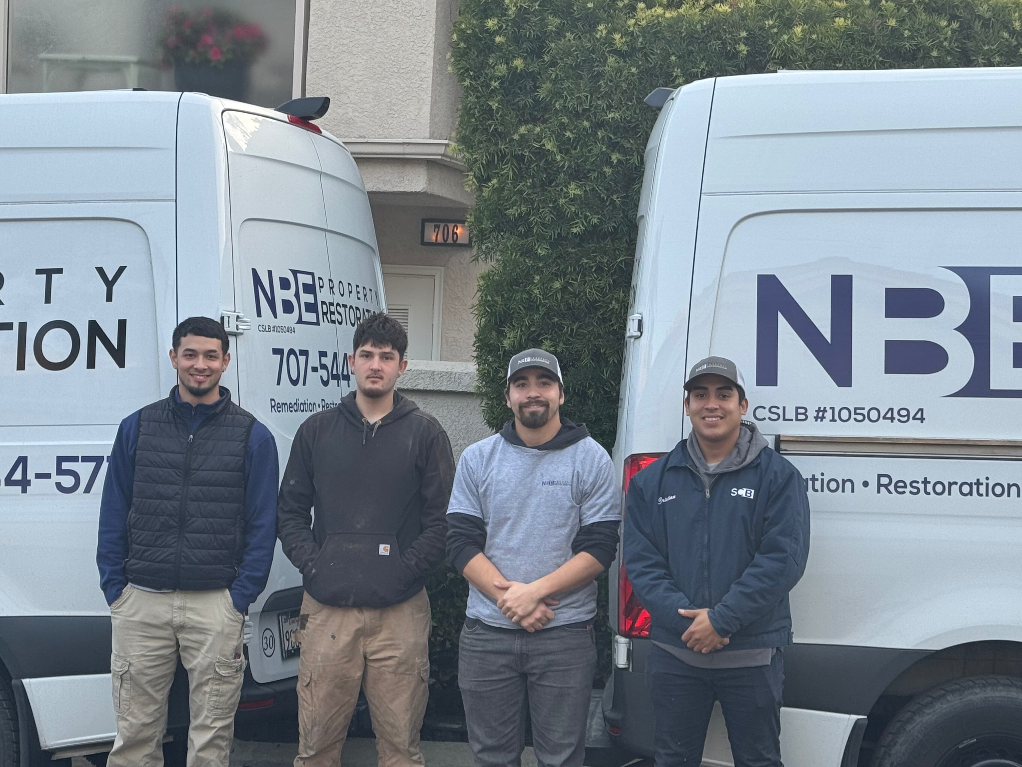 NBE Property Restoration mold remediation crew with company vehicles